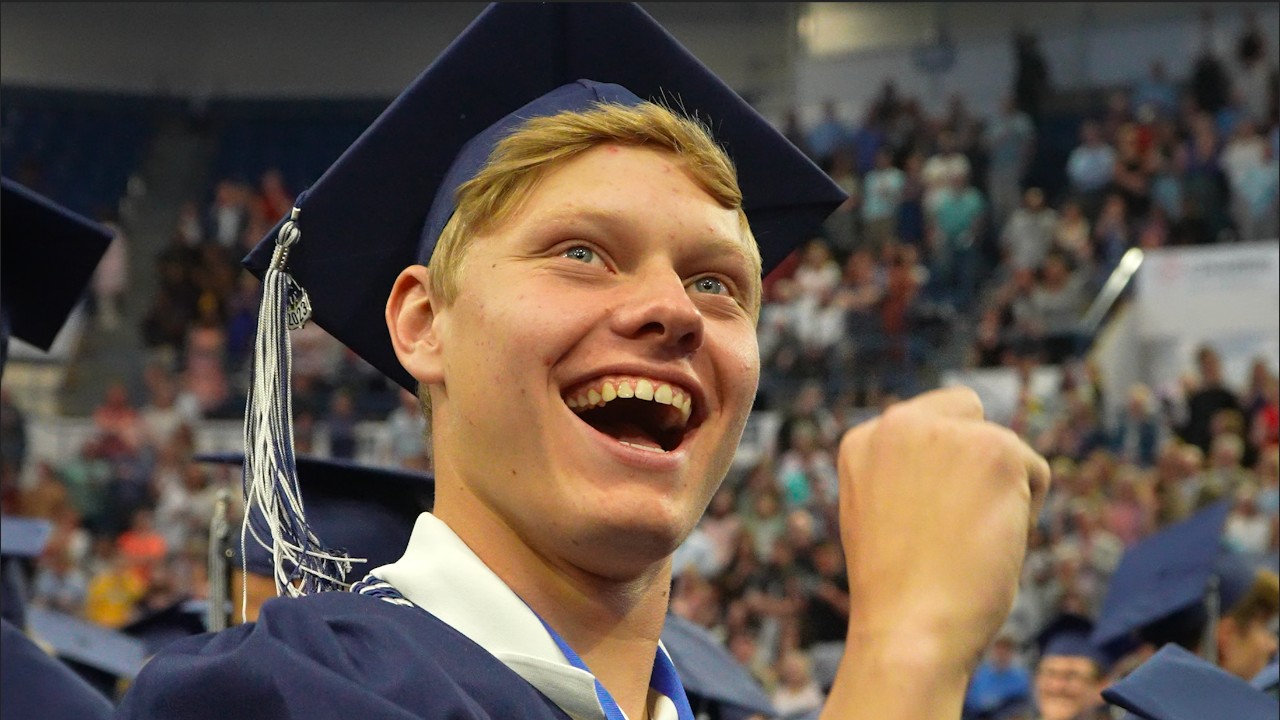 An AAHS graduate smiles during our 2023 graduation ceremony.